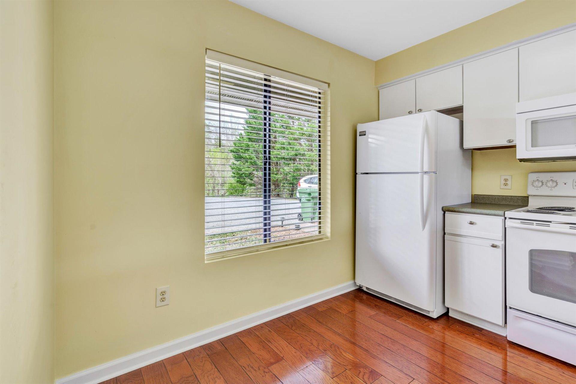 202 Harbor Ridge Drive Goodview, VA 24095 - Photo 6 of 30 a kitchen with a refrigerator and a stove top oven
