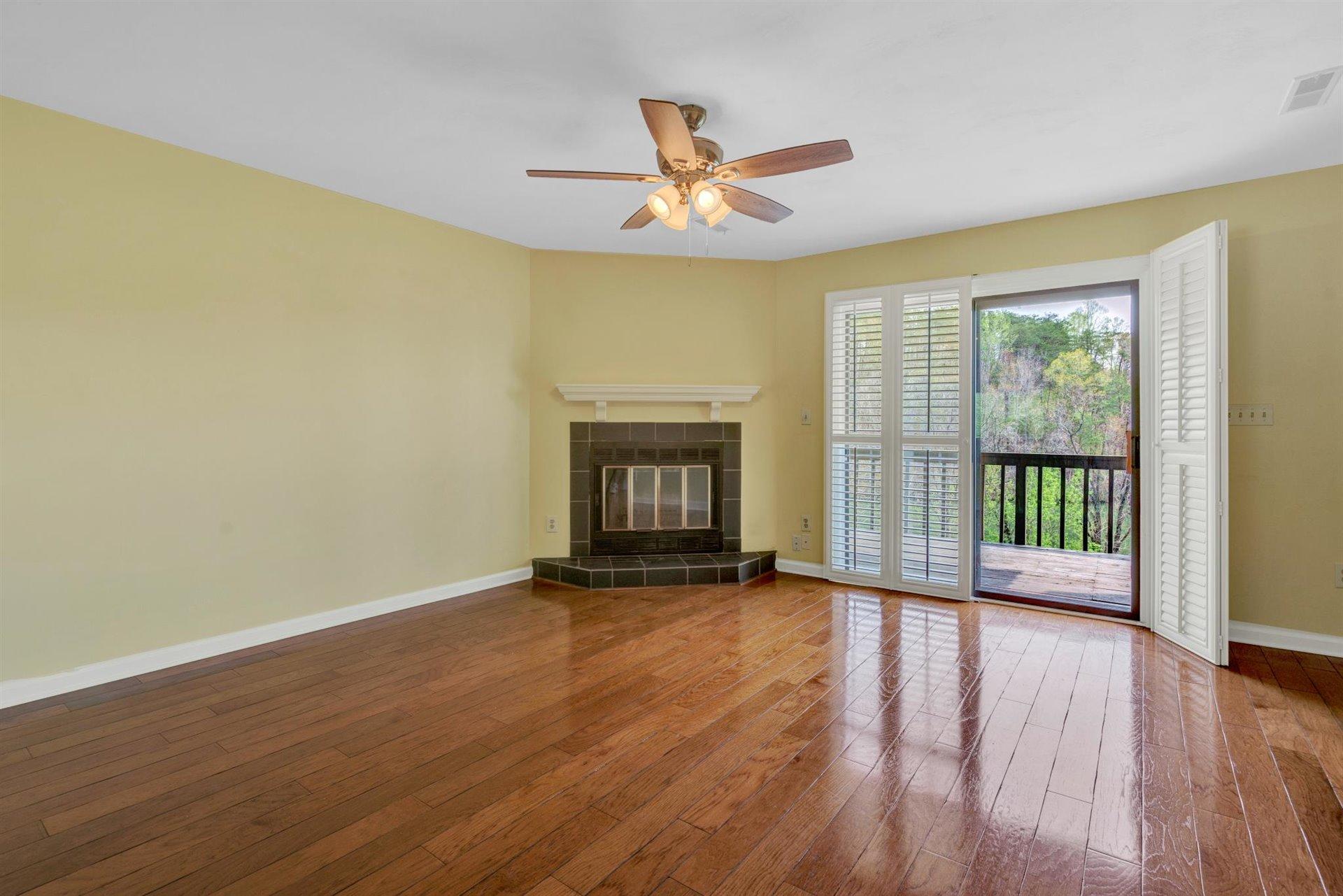 202 Harbor Ridge Drive Goodview, VA 24095 - Photo 8 of 30 a view of an empty room with a window and wooden floor