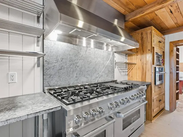 a white stove top oven sitting inside of a kitchen