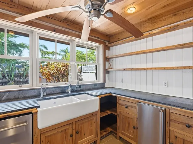 a kitchen with a sink and large window