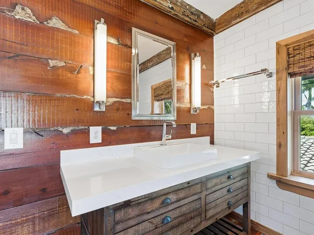 a view of granite countertop cabinets and window