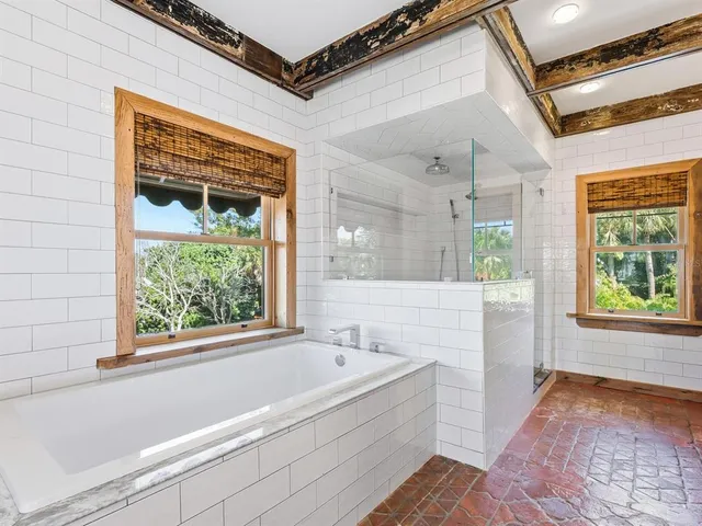 a bathroom with a bathtub and a shower