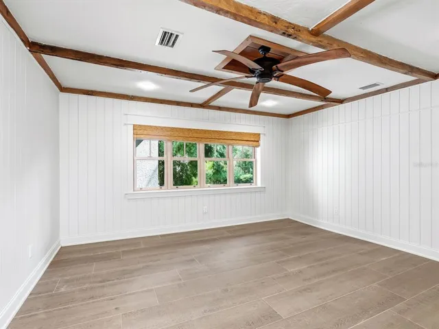 a view of a room with wooden floor and windows