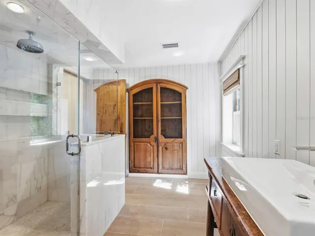 a view of a bathroom with a tub and shower