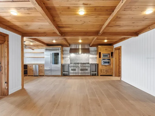 a view of a hall with wooden ceiling