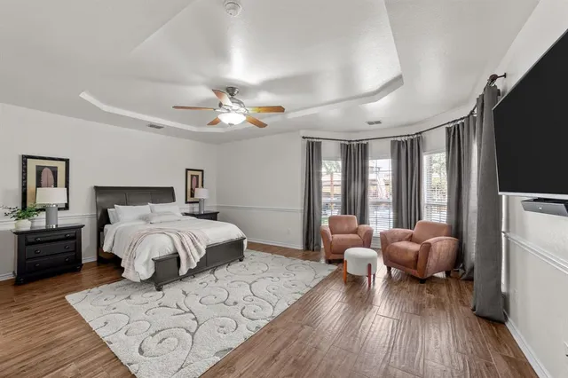 a spacious bedroom with a bed and a large window