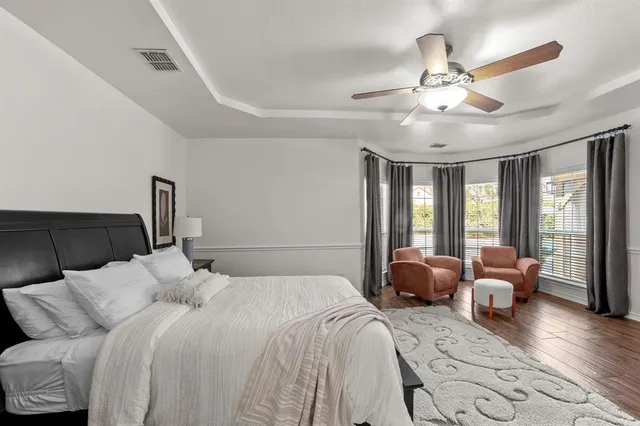 a bedroom with bed and wooden floor