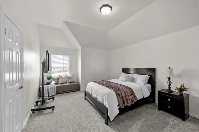 a bedroom with a bed and window