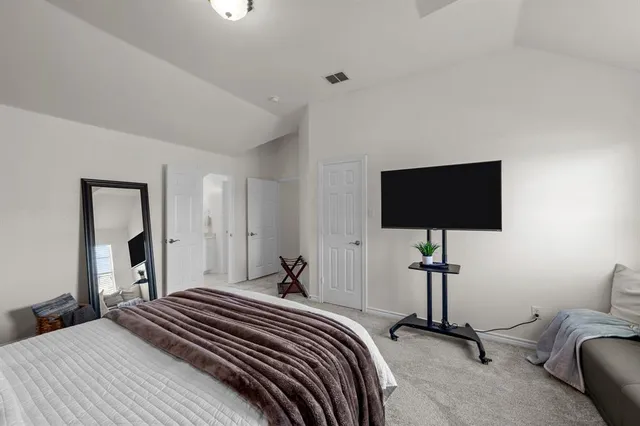 a bedroom with a bed and a flat screen tv