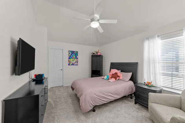 a bedroom with a bed and flat screen tv