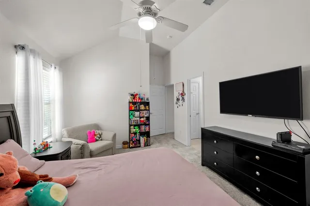 a bedroom with a bed and flat screen tv