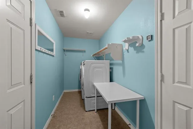 a roof deck with couches and potted plants