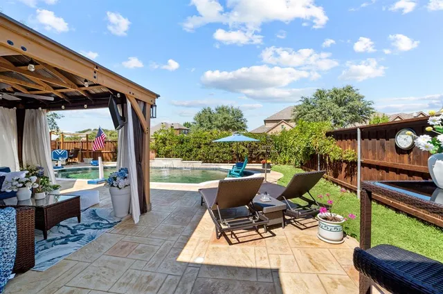 a front view of a house with a yard table and chairs