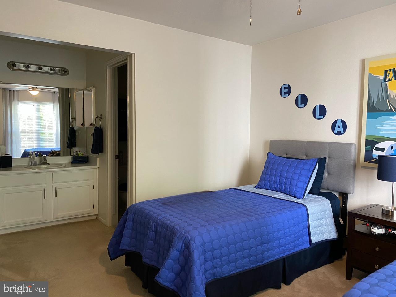 602 Squire Lane, Unit D Bel Air, MD 21014 - Photo 17 of 28 a bedroom with a large bed and paintings on the wall