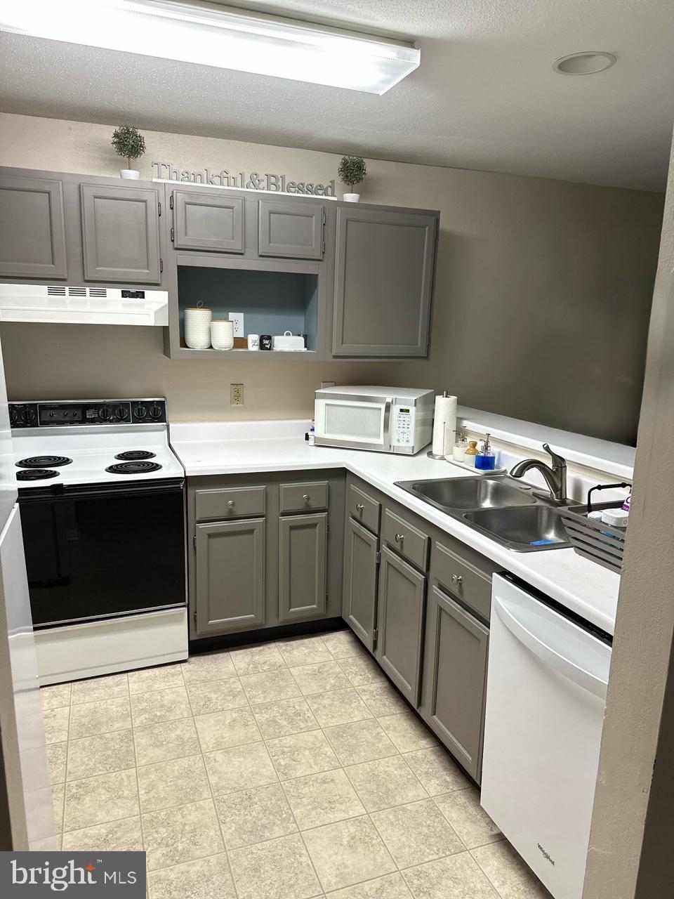602 Squire Lane, Unit D Bel Air, MD 21014 - Photo 9 of 28 a kitchen with a sink a stove and cabinets