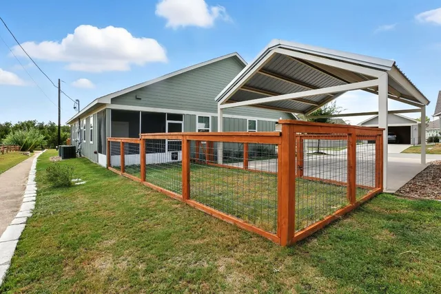 a view of a backyard with a garden and deck