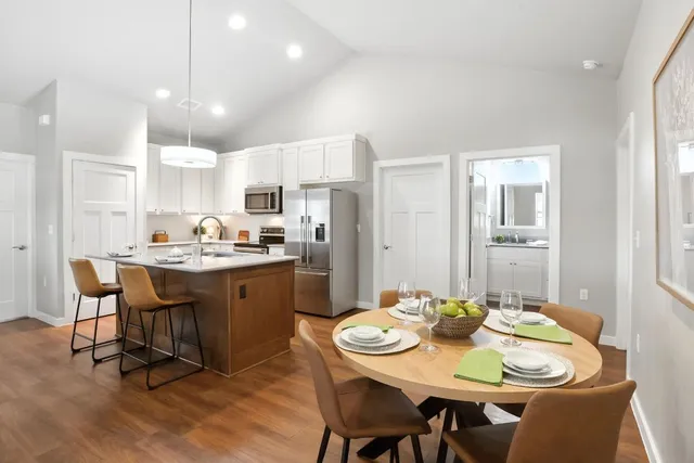 a living room with stainless steel appliances kitchen island granite countertop furniture and a kitchen view