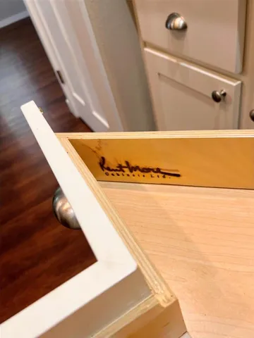 a kitchen with cabinets stainless steel appliances and a counter space
