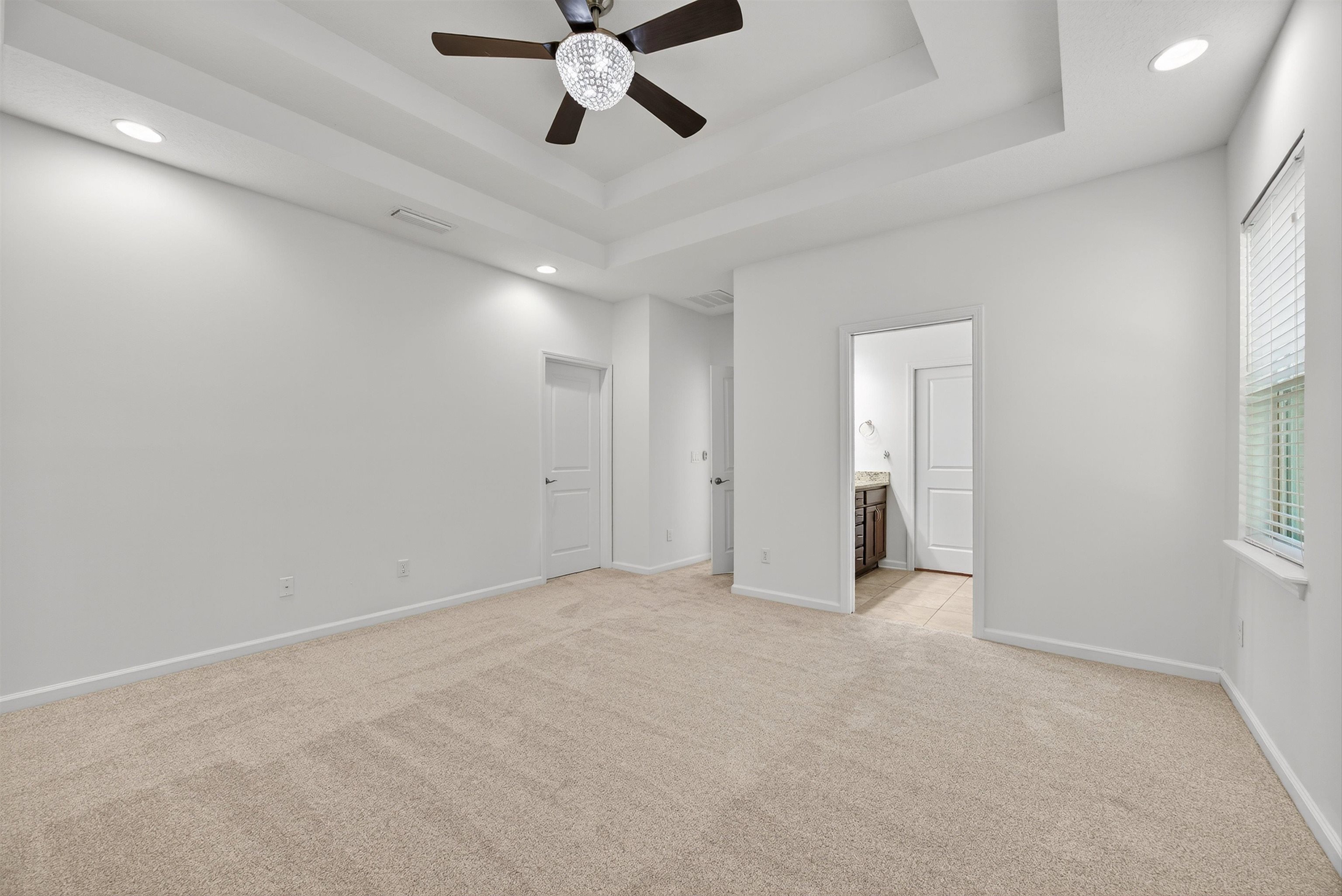 415 Balearics Drive St. Augustine, FL 32086 - Photo 15 of 30 an empty room with chandelier fan and windows
