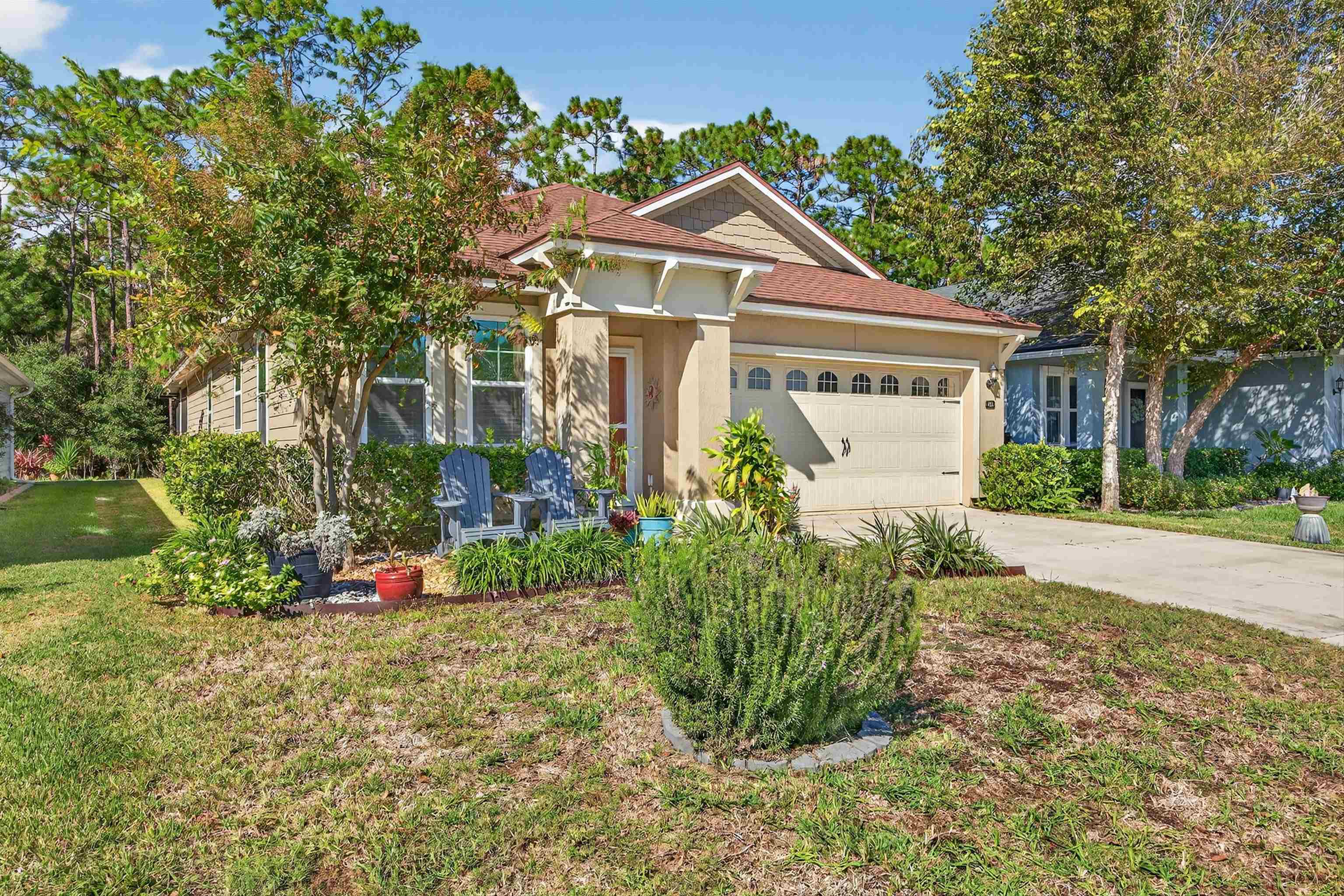 415 Balearics Drive St. Augustine, FL 32086 - Photo 3 of 30 a front view of a house with a yard and potted plants
