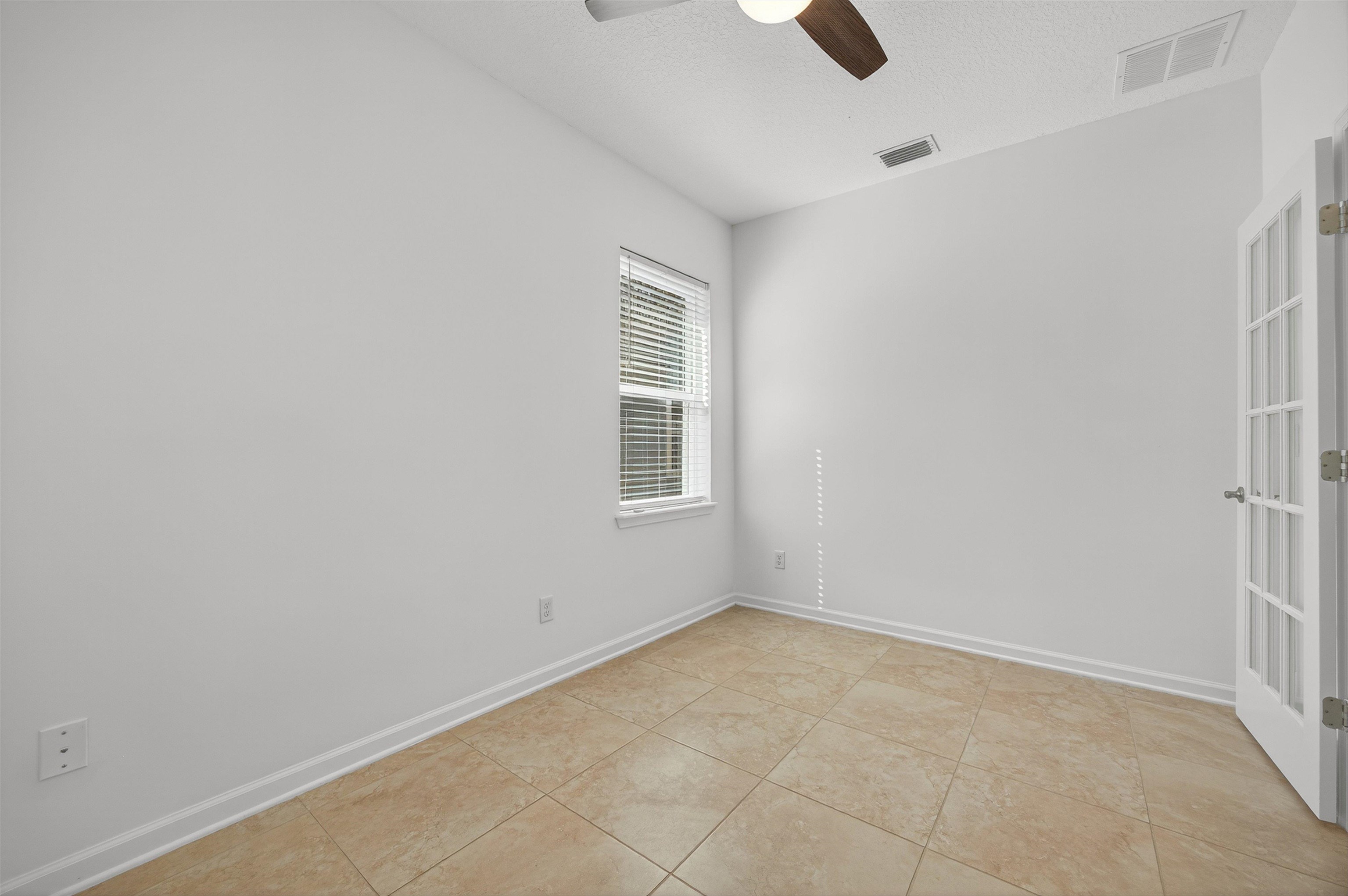 415 Balearics Drive St. Augustine, FL 32086 - Photo 5 of 30 an empty room with windows and ceiling fan