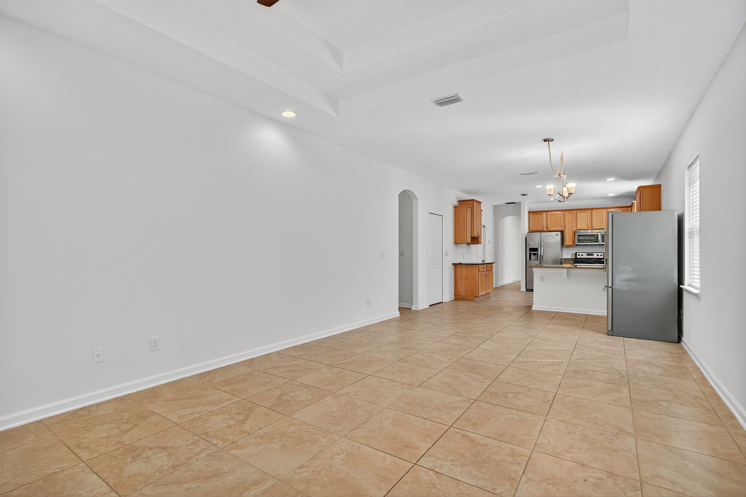 415 Balearics Drive St. Augustine, FL 32086 - Photo 9 of 30 a view of a kitchen with a refrigerator a stove top oven and cabinets