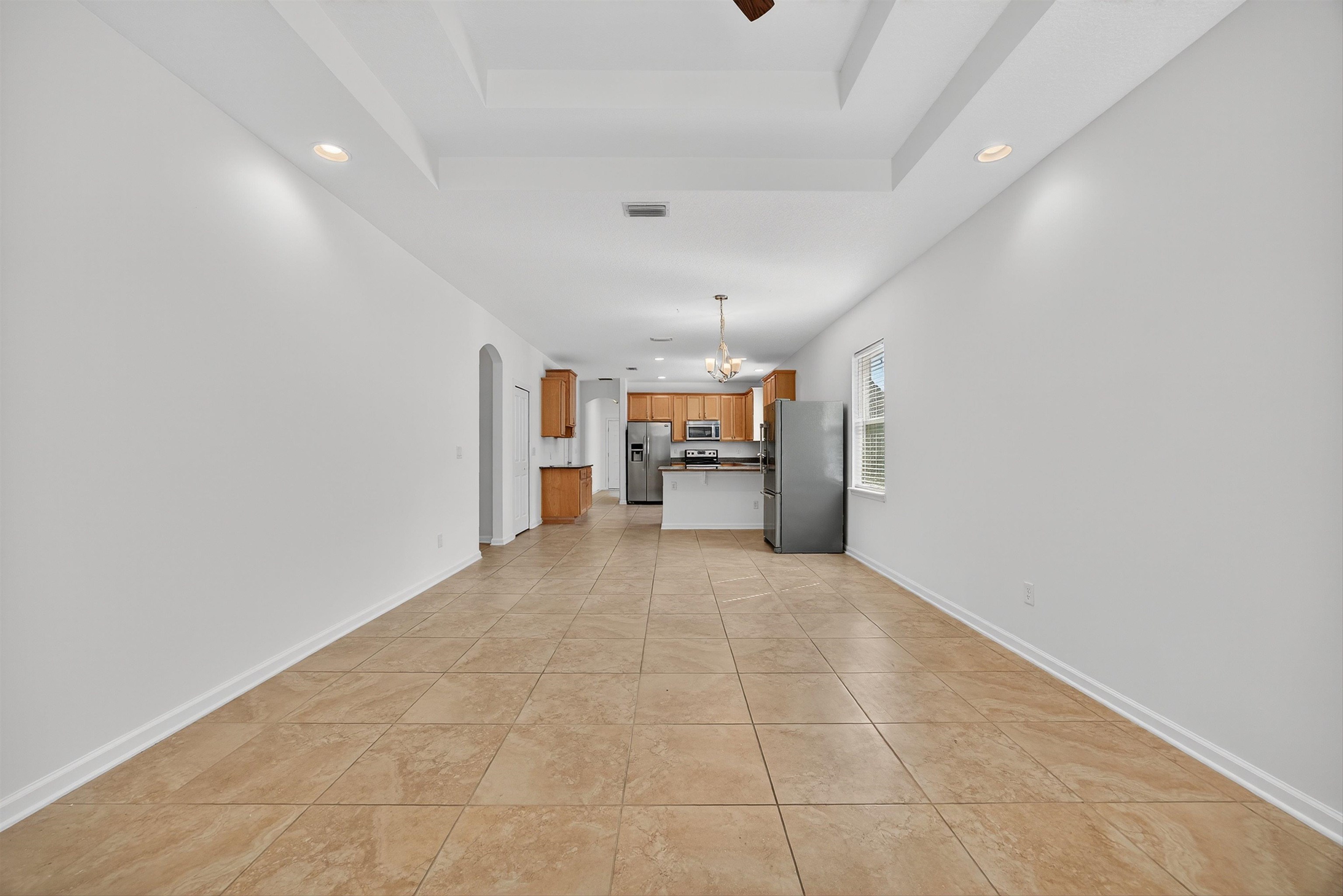 415 Balearics Drive St. Augustine, FL 32086 - Photo 10 of 30 a big room with chandelier fan and windows