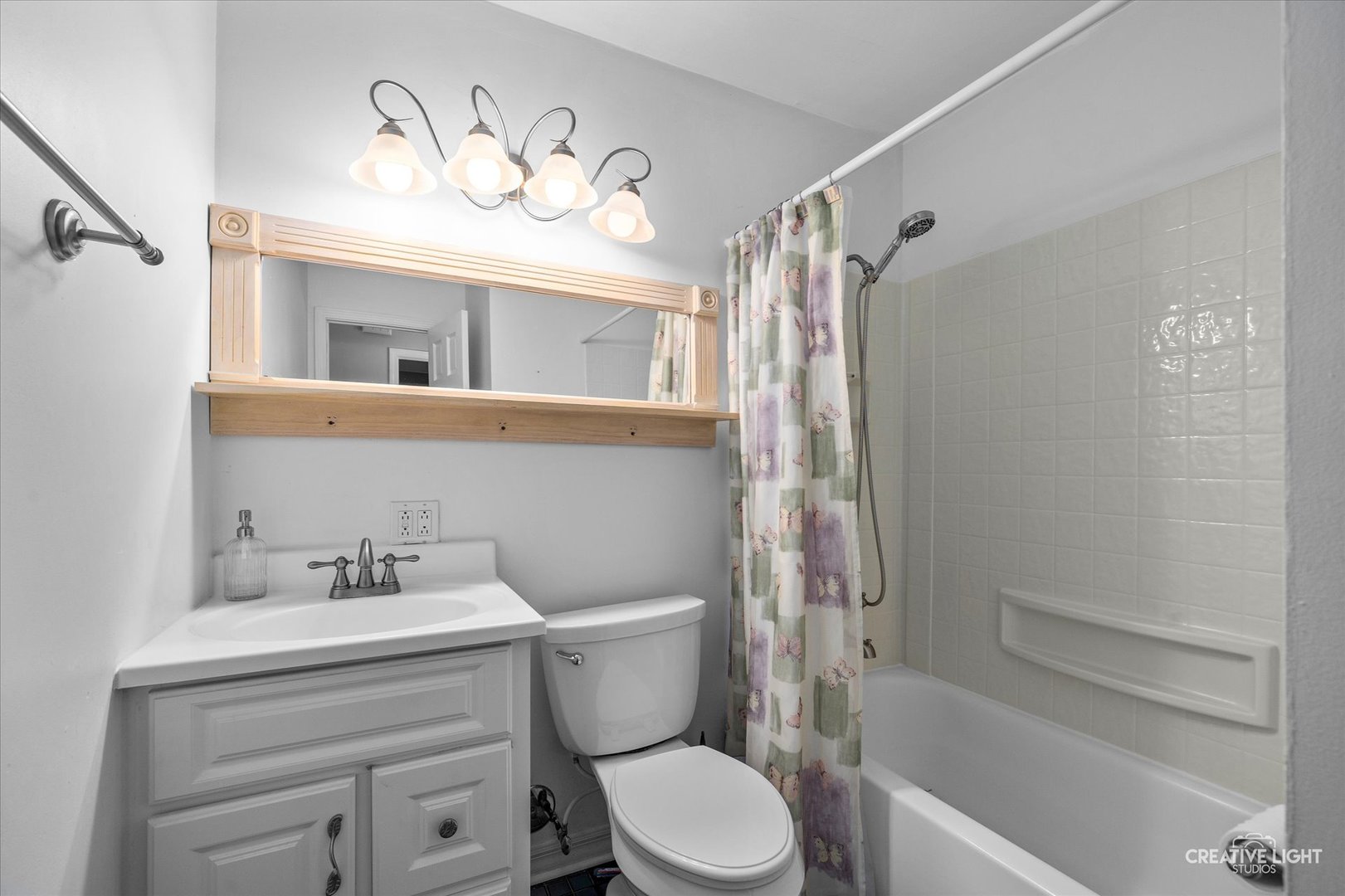 1489 Woodcutter Lane, Unit A Wheaton, IL 60189 - Photo 13 of 20 a bathroom with a sink mirror vanity and toilet