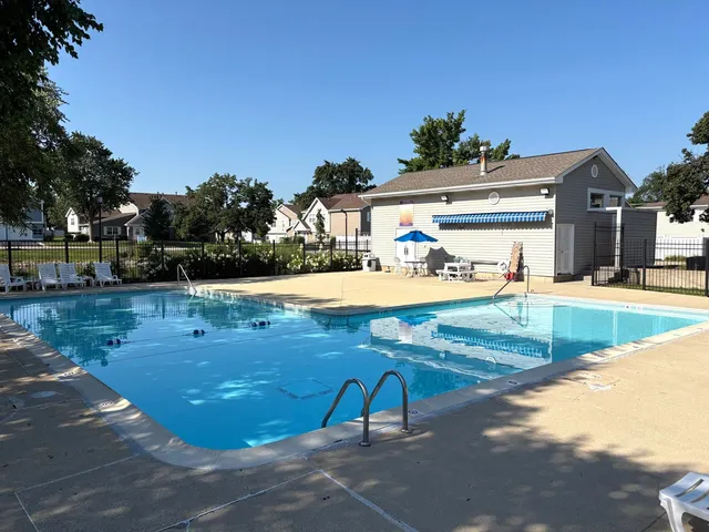 a view of a swimming pool with lounge chair