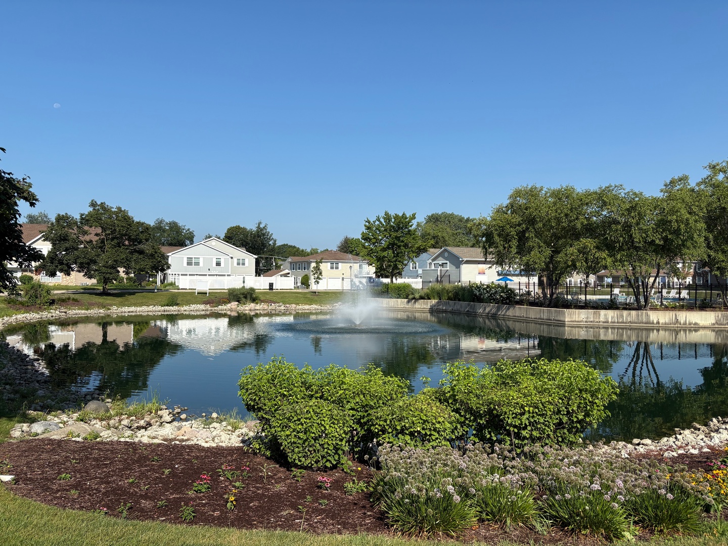 1489 Woodcutter Lane, Unit A Wheaton, IL 60189 - Photo 20 of 20 a swimming pool with outdoor seating and lake view