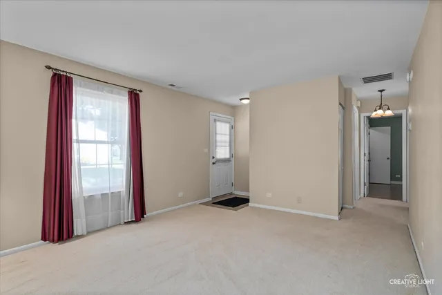 an empty room with windows and bathroom view