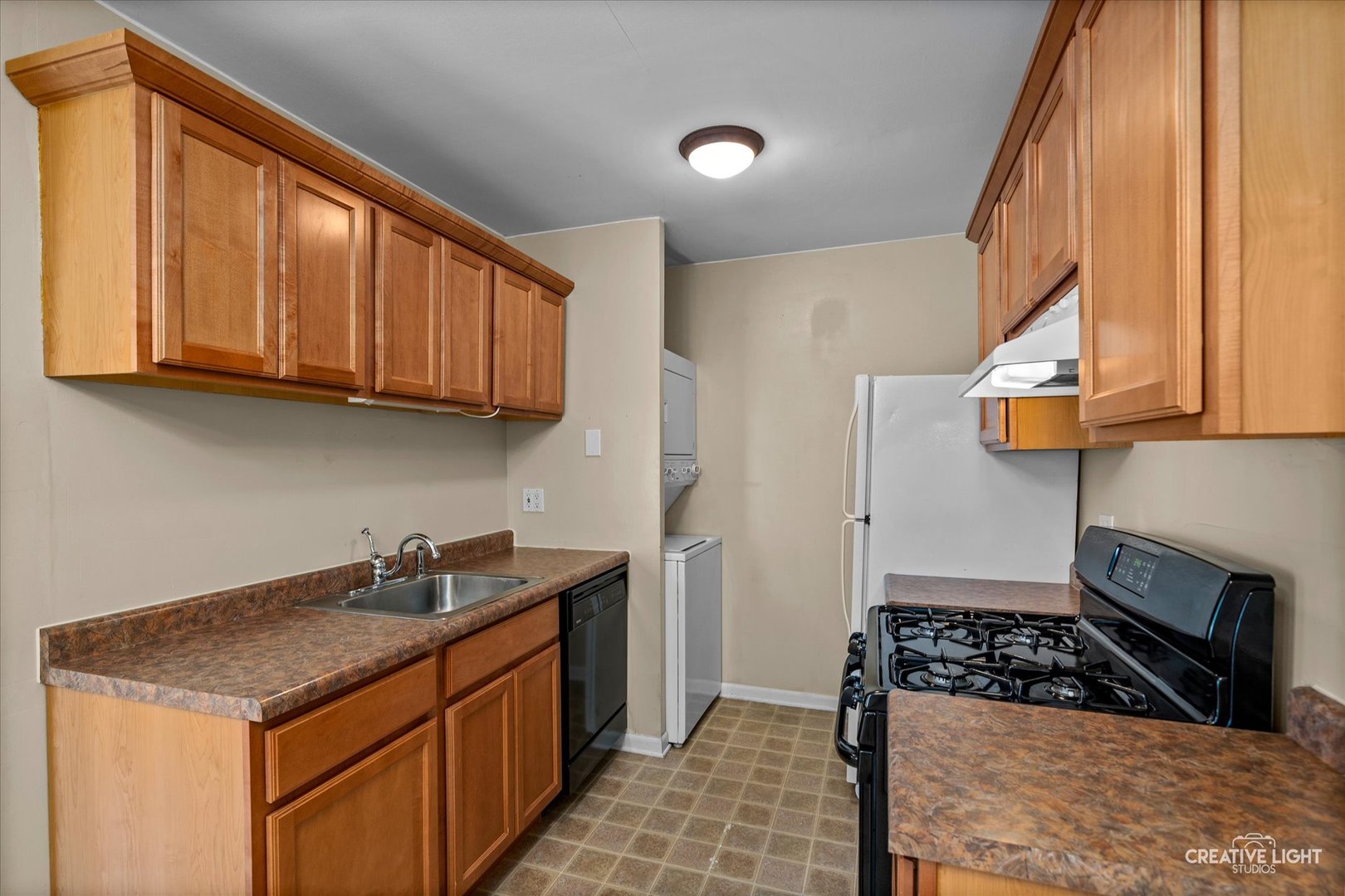 1489 Woodcutter Lane, Unit A Wheaton, IL 60189 - Photo 6 of 20 a kitchen with stainless steel appliances granite countertop a sink stove and cabinets