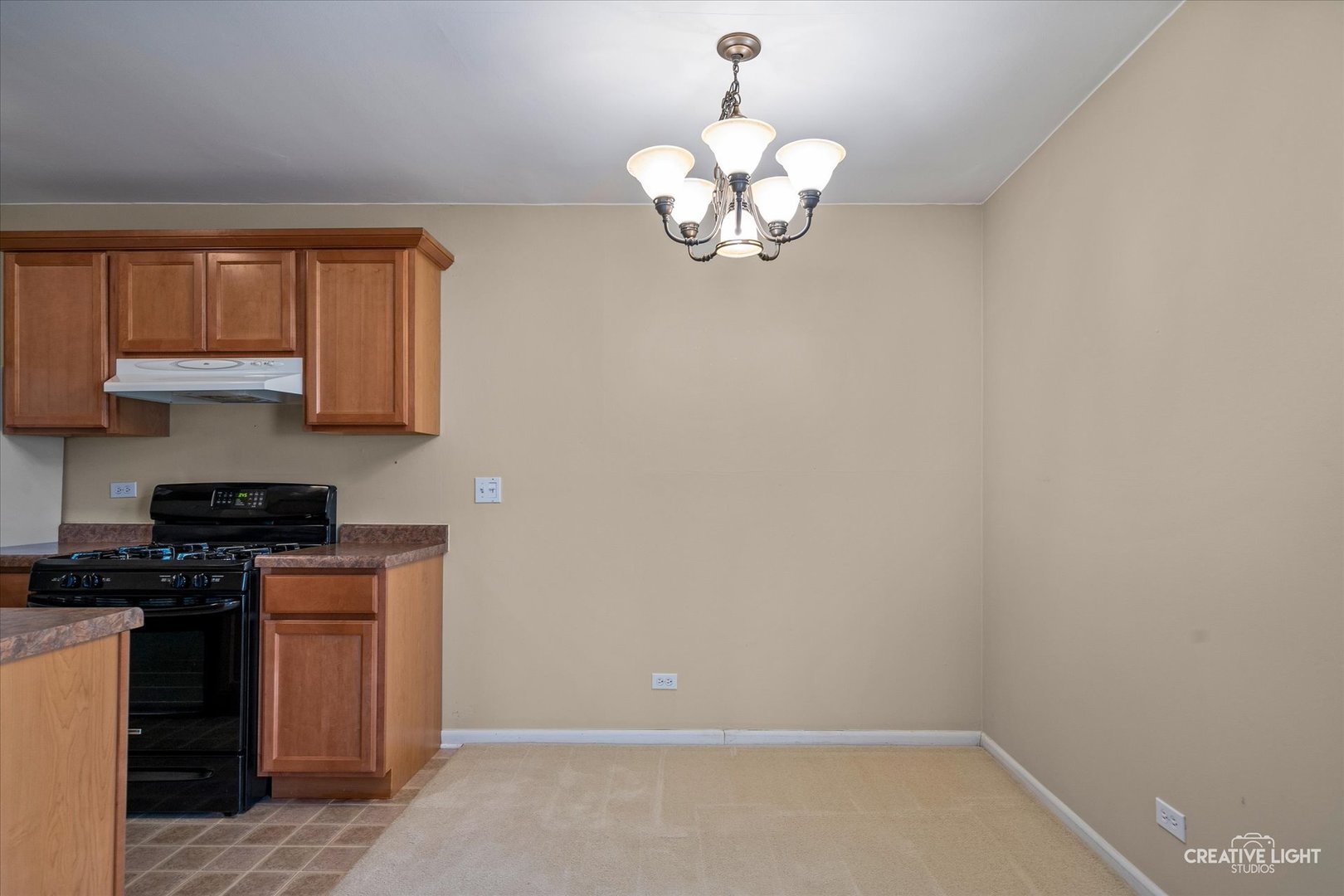 1489 Woodcutter Lane, Unit A Wheaton, IL 60189 - Photo 7 of 20 a view of a kitchen with a sink a kitchen island and chandelier