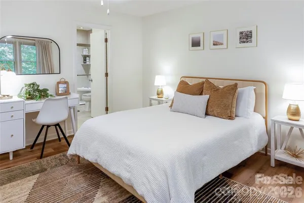 a bedroom with a bed a table and chair