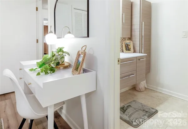 a bathroom with a tub sink and mirror
