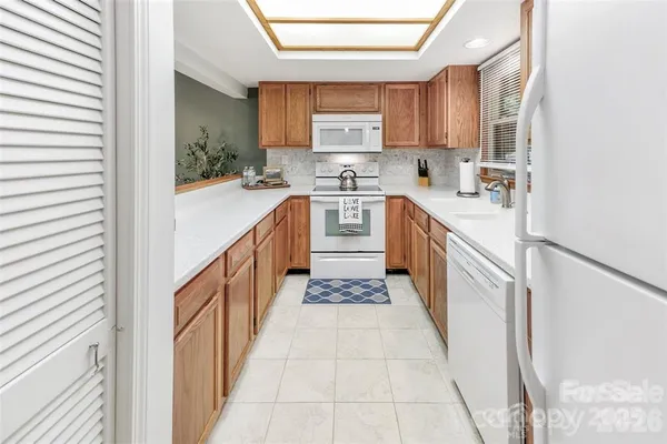 a kitchen with stainless steel appliances granite countertop a sink and cabinets