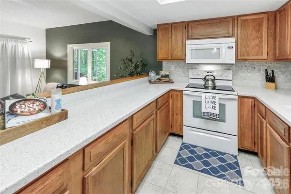 a kitchen with stainless steel appliances granite countertop a sink stove and cabinets
