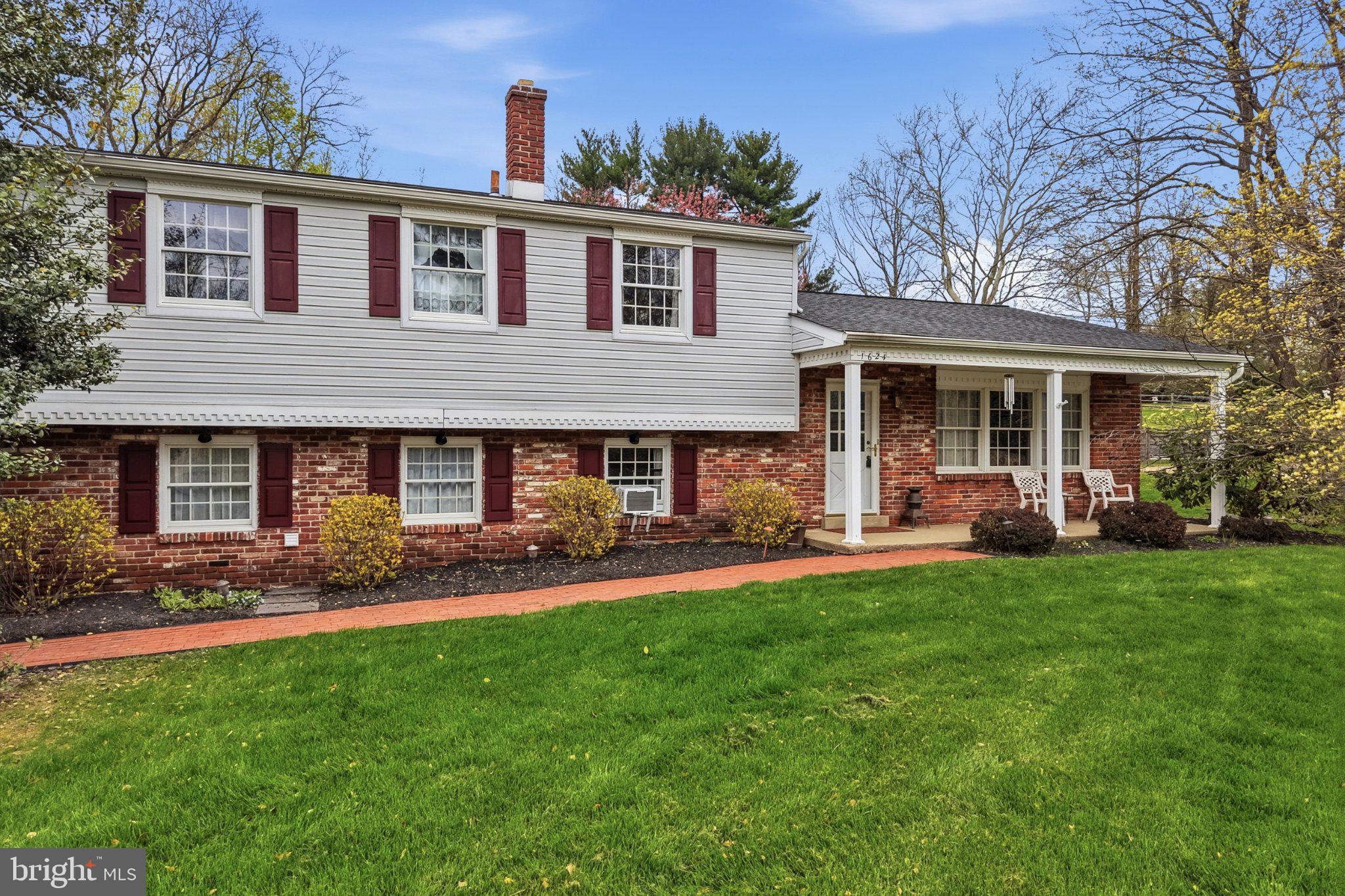 a front view of a house with a garden and patio