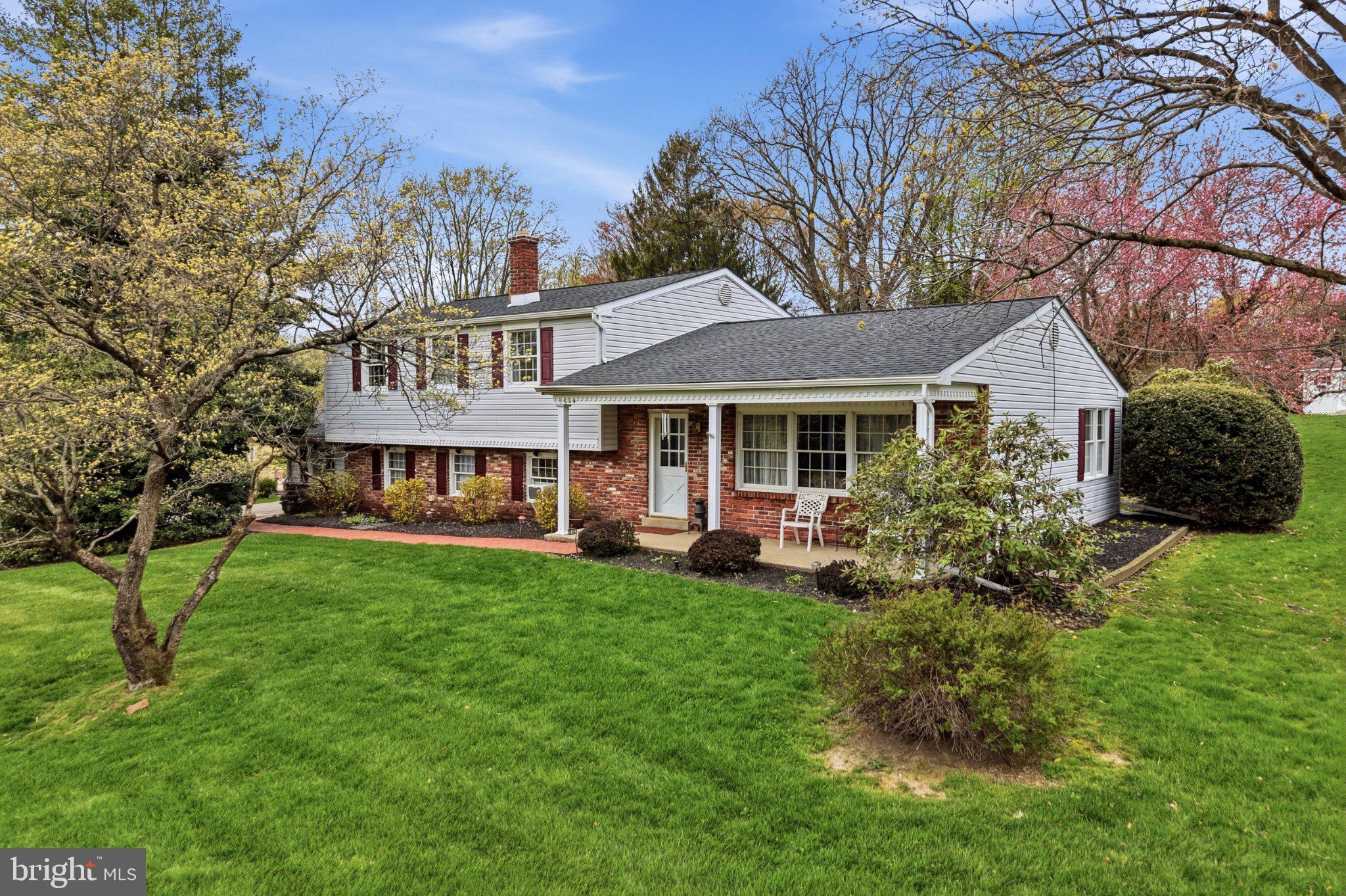 1624 Dillon Road Ambler, PA 19002 - Photo 2 of 47 a front view of a house with a garden and trees
