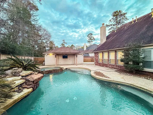 a house with swimming pool in front of it
