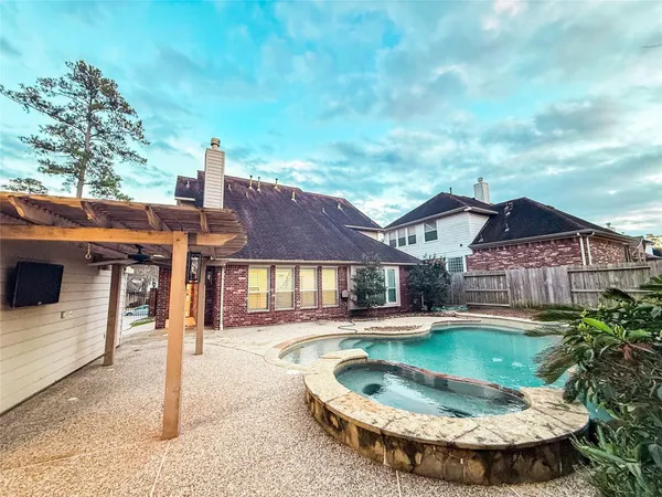 a view of a house with swimming pool and a yard