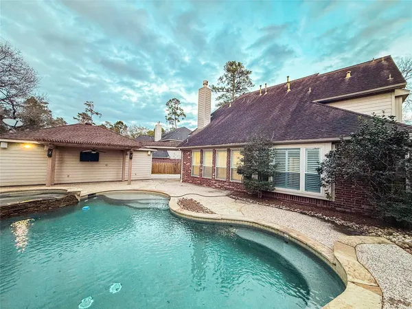 a view of a house with pool yard and sitting area