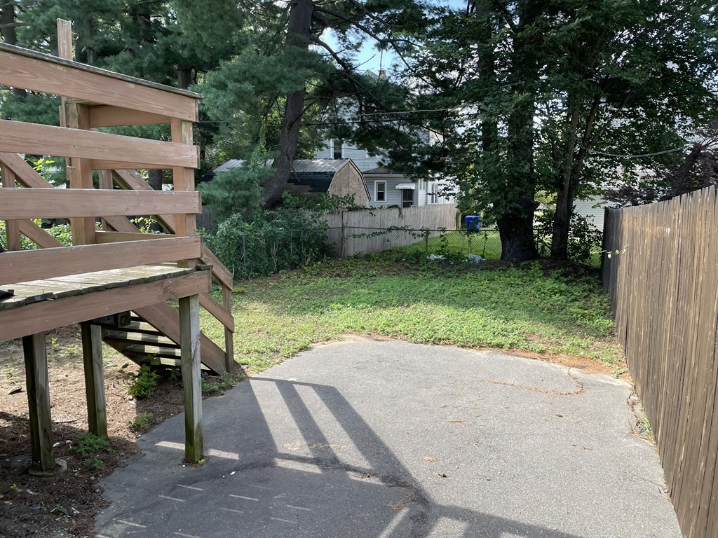 408 Nottingham Street Springfield, MA 01104 - Photo 12 of 12 a view of a house with backyard and a tree