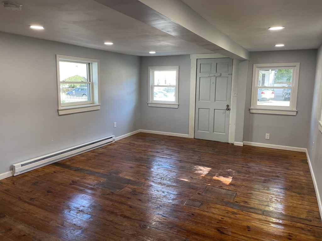 408 Nottingham Street Springfield, MA 01104 - Photo 3 of 12 a view of an empty room with wooden floor and a window