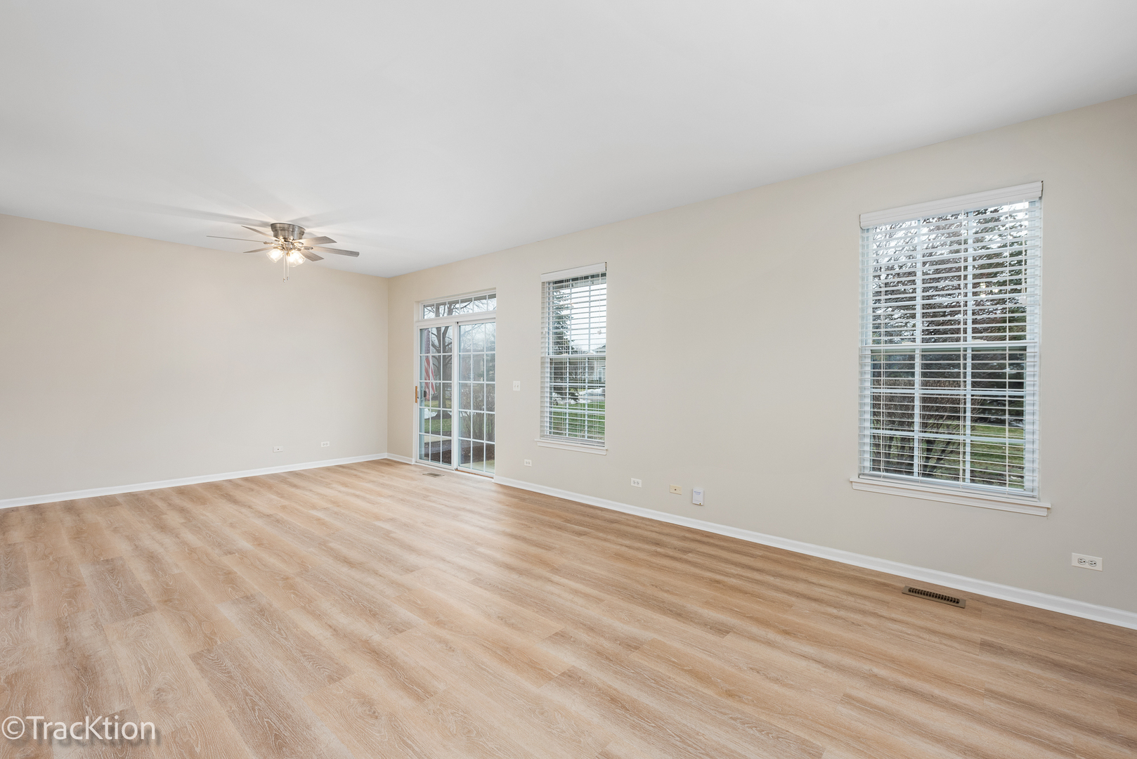 220 Brompton Lane, Unit A Sugar Grove, IL 60554 - Photo 7 of 19 a view of an empty room with wooden floor and a window