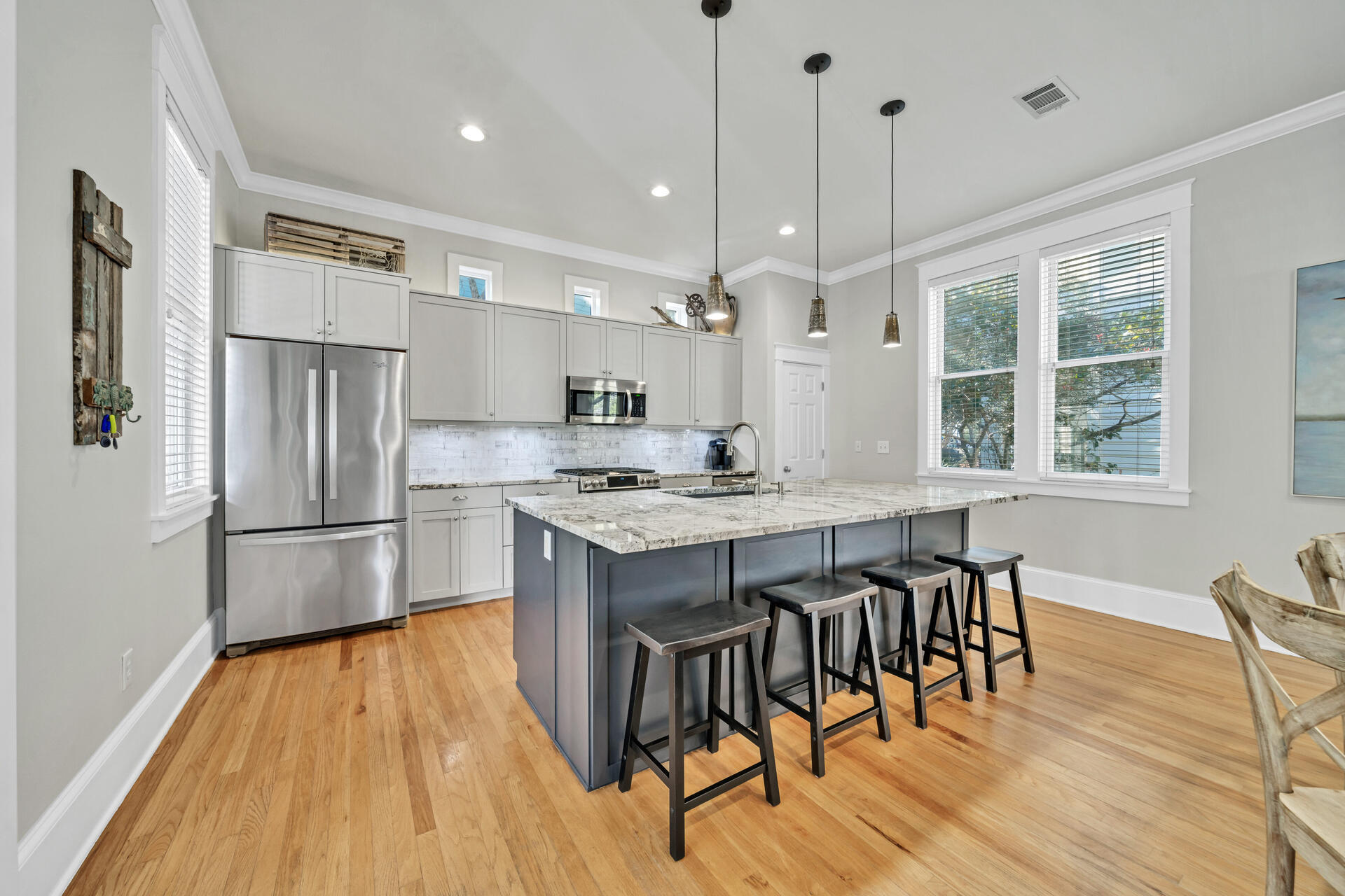 107 Chelsea Loop Road Santa Rosa Beach, FL 32459 - Photo 15 of 66 a kitchen with stainless steel appliances granite countertop a refrigerator a stove a sink dishwasher and a dining table with wooden floor