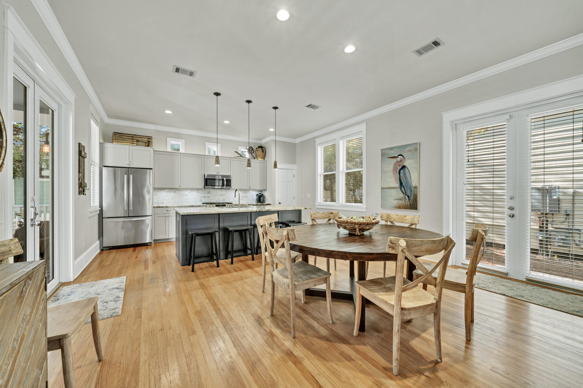 107 Chelsea Loop Road Santa Rosa Beach, FL 32459 - Photo 16 of 66 a kitchen with stainless steel appliances kitchen island granite countertop a stove a refrigerator a dining table and chairs with wooden floor