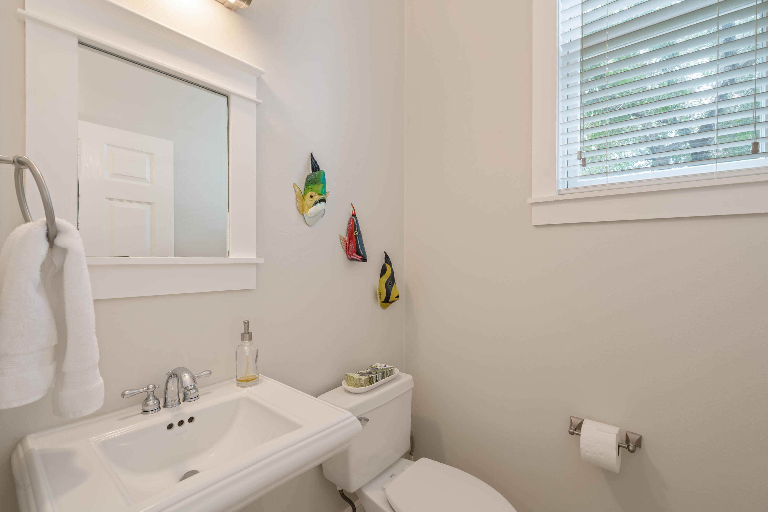 107 Chelsea Loop Road Santa Rosa Beach, FL 32459 - Photo 22 of 66 a bathroom with a toilet sink and mirror