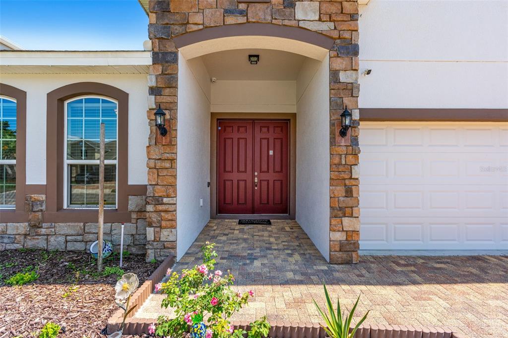 2085 Lula Road Minneola, FL 34715 - Photo 2 of 39 a front view of a house with a garden