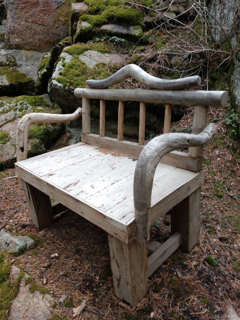 8116 South Brook Forest Road Evergreen, CO 80439 - Photo 8 of 8 front view of a house with a porch